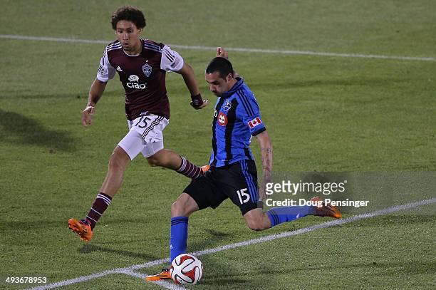 Andres Romero of the Montreal Impact strikes the ball for a goal in the 88th minute against Chris Klute of the Colorado Rapids at Dick's Sporting...