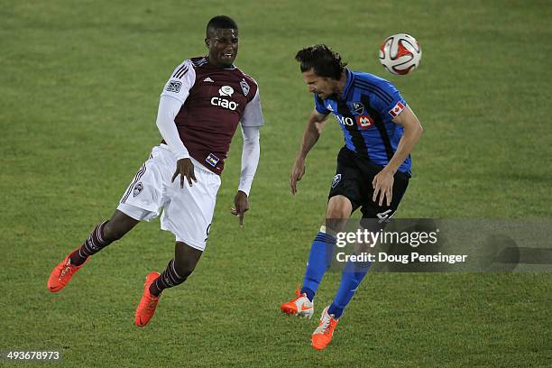 Edson Buddle of the Colorado Rapids and Heath Pearce of the Montreal Impact vie for the ball at Dick's Sporting Goods Park on May 24, 2014 in...