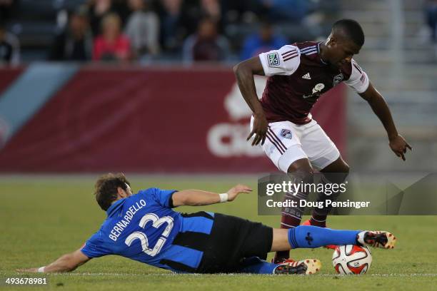 Hernan Bernardello of the Montreal Impact wins the ball away from Edson Buddle of the Colorado Rapids at Dick's Sporting Goods Park on May 24, 2014...