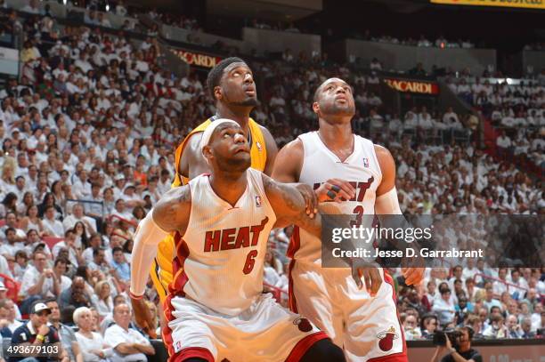 LeBron James and Dwyane Wade of the Miami Heat box out Roy Hibbert of the Indiana Pacers in Game Three of the Eastern Conference Semifinals during...