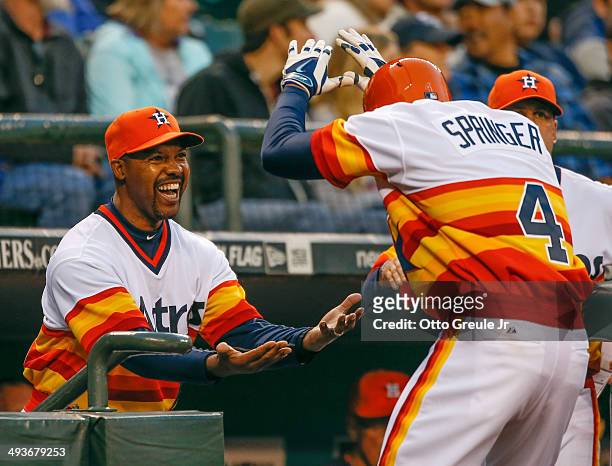 George Springer of the Houston Astros is congratulated by manager Bo Porter after hitting a two-run home run in the fifth inning against the Seattle...