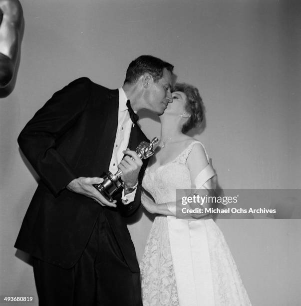 Actor Charlton Heston receives a kiss from Susan Hayward after winning the Academy Award for "Ben Hur" in Los Angeles, California.
