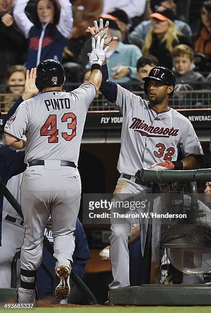 Josmil Pinto of the Minnesota Twins is congratulated by Aaron Hicks after Pinto hit a solo home run against the San Francisco Giants in the top of...