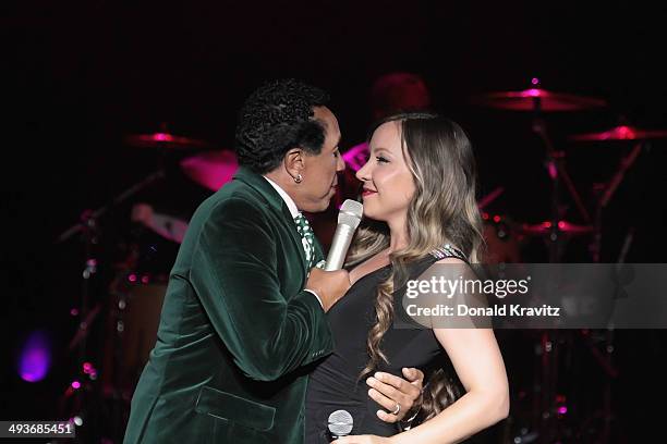 Smokey Robinson and a back-up singer perform at Harrah's Resort on May 24, 2014 in Atlantic City, New Jersey.