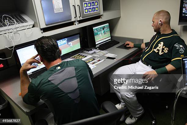 Luke Gregerson and Daric Barton of the Oakland Athletics study video in the clubhouse prior to the game against the Seattle Mariners at O.co Coliseum...
