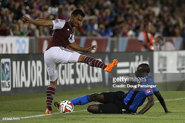 Hassoun Camara of the Montreal Impact wins the ball against Kamani Hill of the Colorado Rapids at Dick's Sporting Goods Park on May 24, 2014 in...