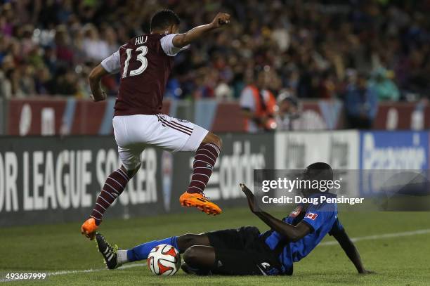 Hassoun Camara of the Montreal Impact wins the ball against Kamani Hill of the Colorado Rapids at Dick's Sporting Goods Park on May 24, 2014 in...