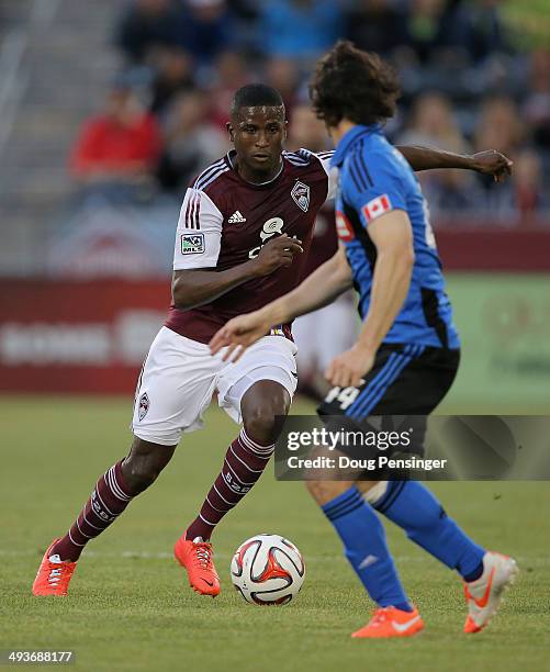 Edson Buddle of the Colorado Rapids controls the ball against Heath Pearce of the Montreal Impact at Dick's Sporting Goods Park on May 24, 2014 in...
