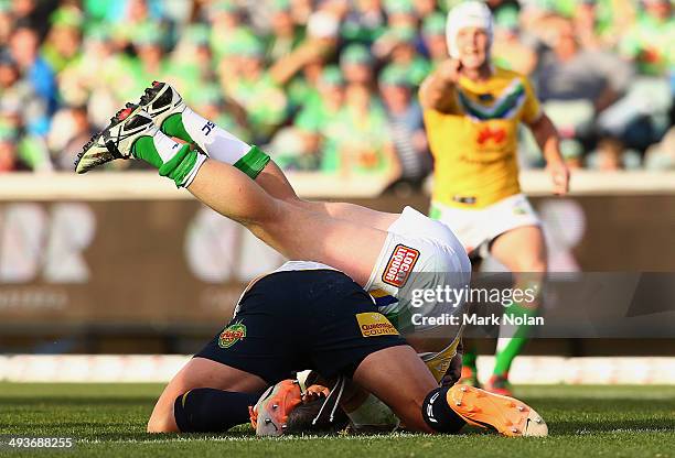 Tariq Sims of the Cowboys dumps Shaun Fensom of the Raiders on his neck during the round 11 NRL match between the Canberra Raiders and the North...