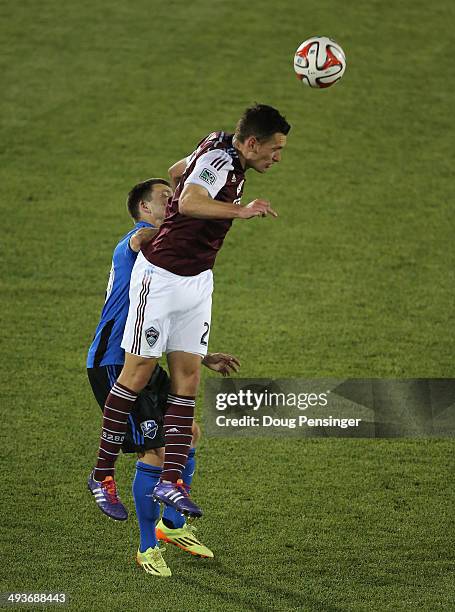 Shane O'Neill of the Colorado Rapids heads the ball away from Jack McInerney of the Montreal Impact at Dick's Sporting Goods Park on May 24, 2014 in...