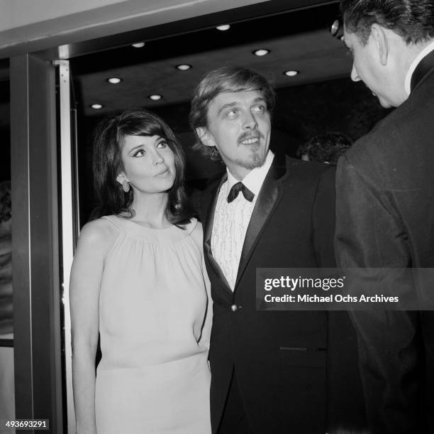 Actor David Hemmings with actress Anjanette Comer arrive at a party in Los Angeles,California.