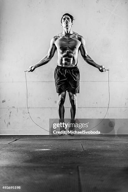 hispanic man jump roping - black and white muscular man stock pictures, royalty-free photos & images