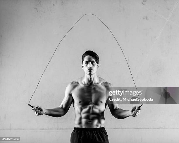 hispanic man jump roping - black and white muscular man stock pictures, royalty-free photos & images