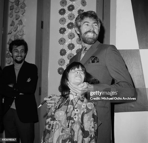 Actor James Coburn with his daughter Lisa attends a premiere in Los Angeles, California.