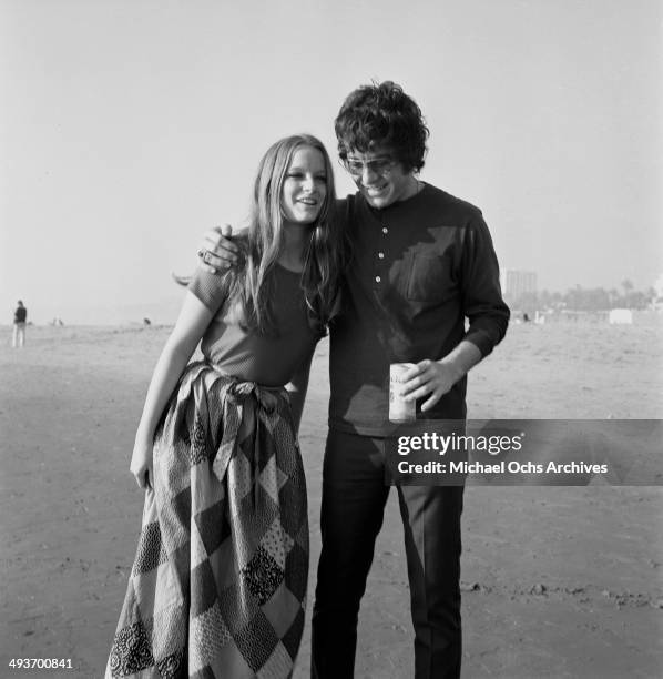 Actor Michael Cole poses at the beach with Claudia Jennings in Los Angeles, California.
