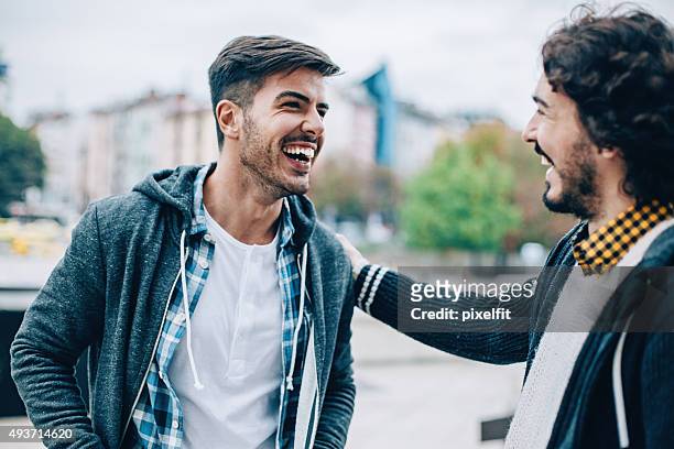 men - young men talking stock pictures, royalty-free photos & images