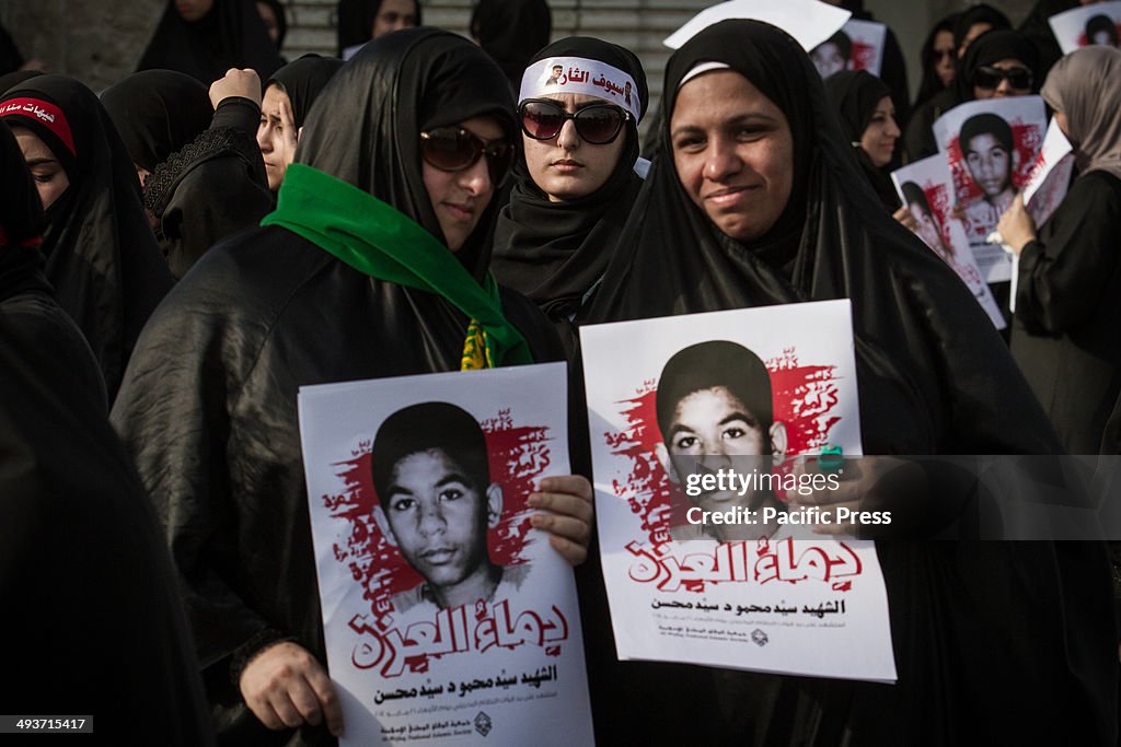 A group of women carrying a portrait of martyr Sayed Mahmoud...