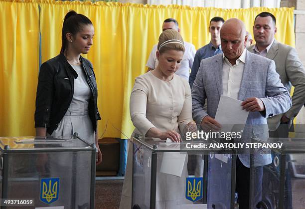 Ukrainian presidential candidate Yulia Tymoshenko casts her ballot alongside her daughter Yevhenia and her husband Olexandr at a polling station in...