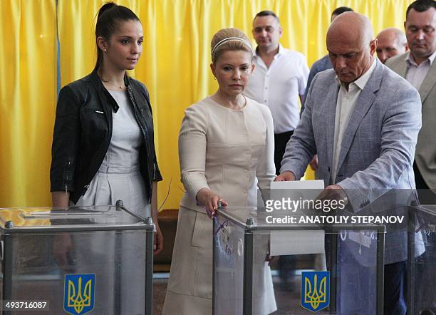 Ukrainian presidential candidate Yulia Tymoshenko casts her ballot alongside her daughter Yevhenia and her husband Olexandr at a polling station in...