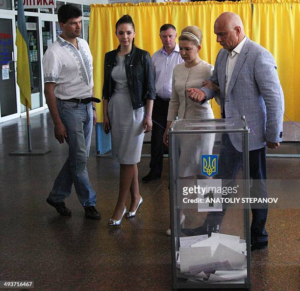 Ukrainian presidential candidate Yulia Tymoshenko arrives to cast her ballot, alongside her daughter Yevhenia and her husband Olexandr , at a polling...
