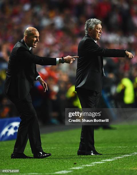 Zinedine Zidane assistant manager of Real Madrid and Carlo Ancelotti manager of Real Madrid signal during the UEFA Champions League Final between...