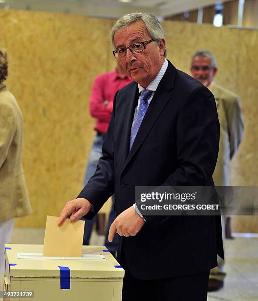 European Commission presidential candidate Jean-Claude Juncker poses on May 25,2014 at the polling station installed at the Culture Centre of...