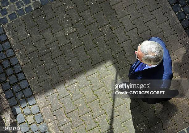 European Commission presidential candidate Jean-Claude Juncker talks with the press after voting on May 25,2014 at the polling station installed at...