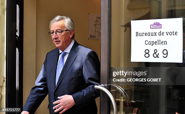 European Commission presidential candidate Jean-Claude Juncker leaves on May 25,2014 the polling station installed at the Culture Centre of Capellen...