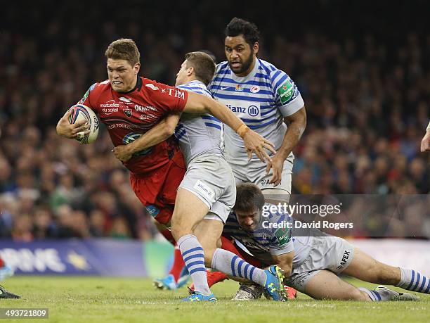 Juan Smith of Toulon is tackled by Richard Wigglesworth during the Heineken Cup Final between Toulon and Saracens at the Millennium Stadium on May...