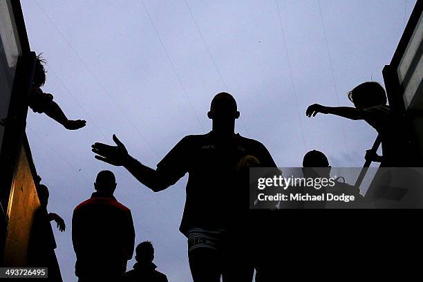 James Podsiadly of the Crows walks past fans after the warm up during the round 10 AFL match between the Carlton Blues and the Adelaide Crows at...