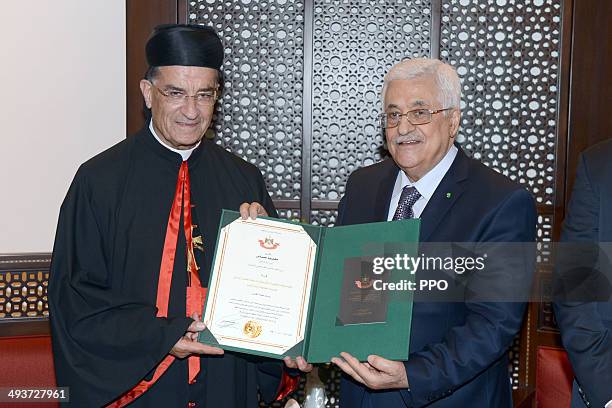 In this handout image supplied by the Palestinian Press Ofiice President, Mahmoud Abbas greets Patriarch of Antioch and All the East, al-Rahi on May...