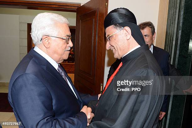 In this handout image supplied by the Palestinian Press Ofiice President, Mahmoud Abbas greets Patriarch of Antioch and All the East, al-Rahi on May...