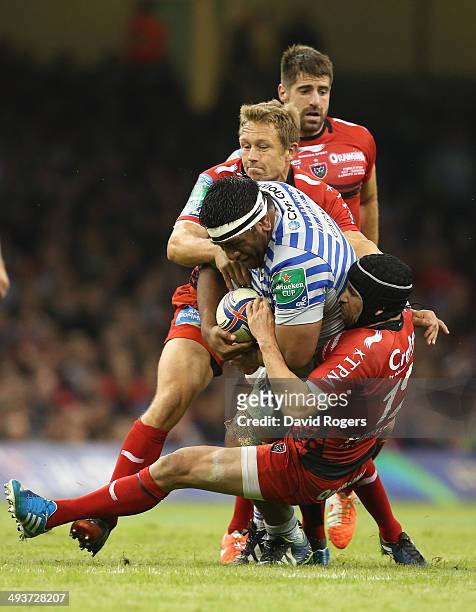 Mako Vunipola of Saracens is tackled by Matt Giteau and Jonny Wilkinson during the Heineken Cup Final between Toulon and Saracens at the Millennium...