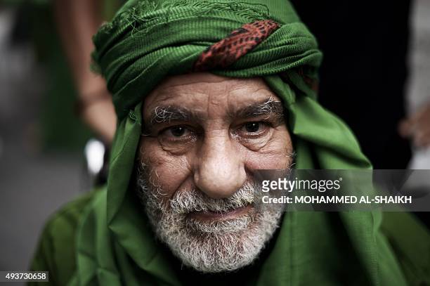 Bahraini Shiite Muslim man poses for a picture during a ceremony commemorating Ashura, which marks the seventh century slaying of Imam Hussein, the...