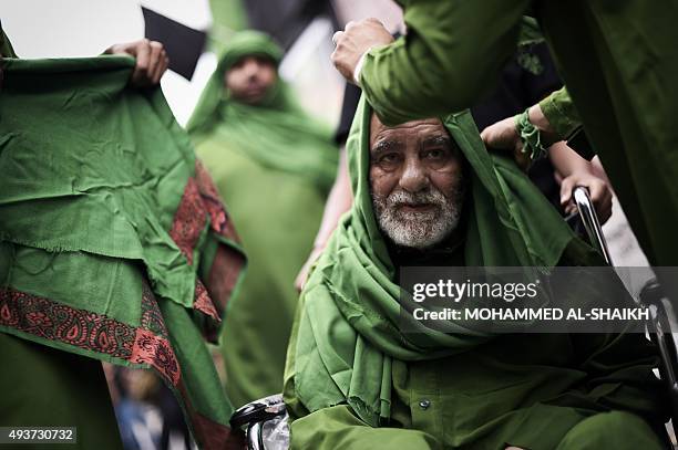 Bahraini Shiite Muslim men take part in a ceremony commemorating Ashura, which marks the seventh century slaying of Imam Hussein, the grandson of...