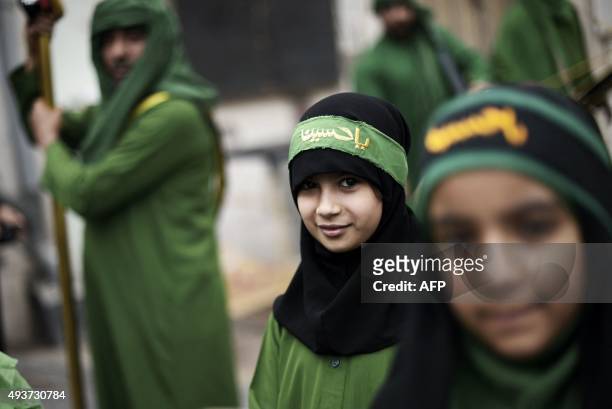 Bahraini Shiite Muslims take part in a ceremony commemorating Ashura, which marks the seventh century slaying of Imam Hussein, the grandson of...
