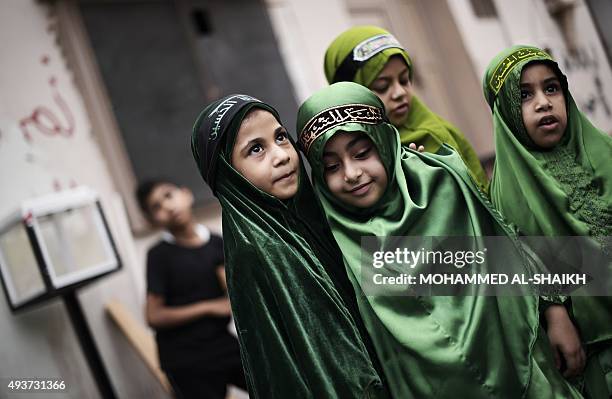 Bahraini Shiite Muslim children take part in a ceremony commemorating Ashura, which marks the seventh century slaying of Imam Hussein, the grandson...