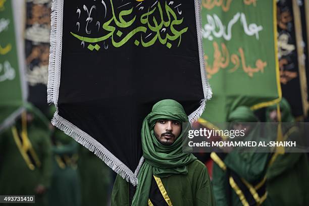 Bahraini Shiite Muslims take part in a ceremony commemorating Ashura, which marks the seventh century slaying of Imam Hussein, the grandson of...