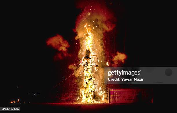 Kashmiri Pandits use sparklers to create shapes as they burn effigies of the demon king Ravana during the Dushera festival on October 22, 2015 in...