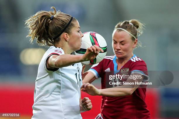 Melanie Leupolz of Germany jumps for a header with Ekaterina Sochneva of Russia during the UEFA Women's Euro 2017 Qualifier match between Germany and...