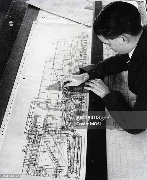 Draughtsman Brian Pearson, an employee in the Drawing Office, working on Drawing for War Department. 1945 '4-8-2+2-8-4' standard light type Garratt...