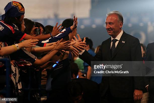 Japan national team manager Alberto Zaccheroni high fives fans during the World Cup send-off press conference for Japanese team on May 25, 2014 in...