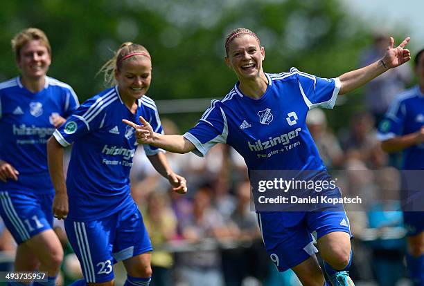 Christine Veth of Sand celebrates her team's first goal with team mates during the women's second Bundesliga match between SC Sand and 1. FC Koeln on...