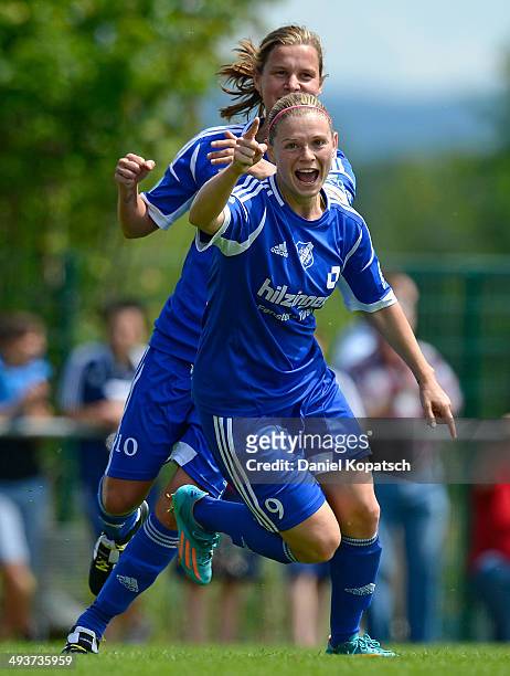 Christine Veth of Sand celebrates her team's first goal with team mates during the women's second Bundesliga match between SC Sand and 1. FC Koeln on...