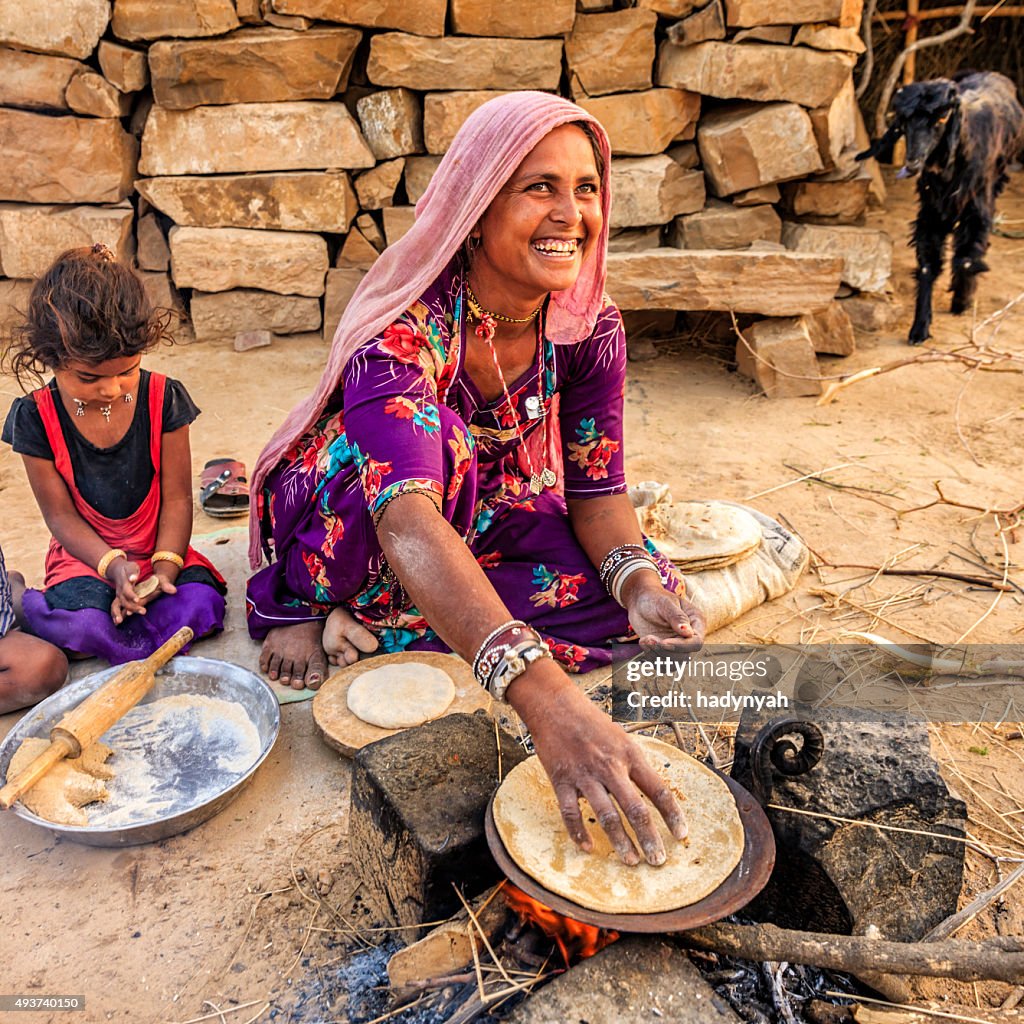 Indian woman preparing food - chapatti, flat bread, desert village