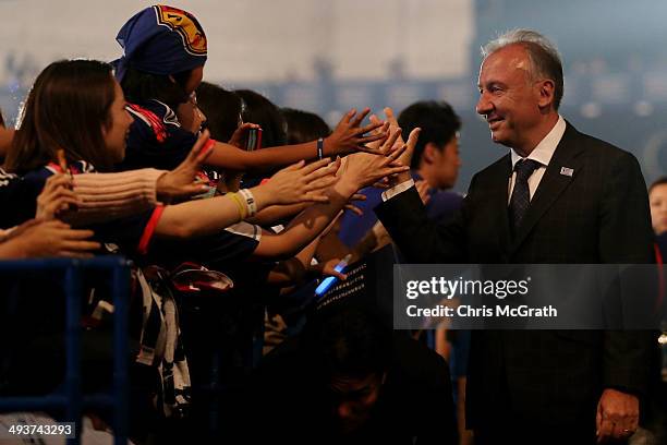 Japan national team manager Alberto Zaccheroni high fives fans during the World Cup send-off press conference for Japanese team on May 25, 2014 in...