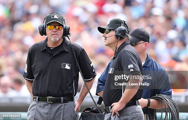 Major League Umpires Ron Kulpa and Ed Hickox review the instant re-play challenge during the game between the Texas Rangers and the Detroit Tigers at...