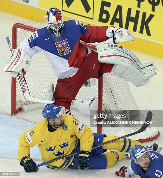 Czech Republic's forward Jan Kovar and Sweden's forward Dick Axelsson slide past Czech Republic's goalie Alexander Salak during a bronze medal game...