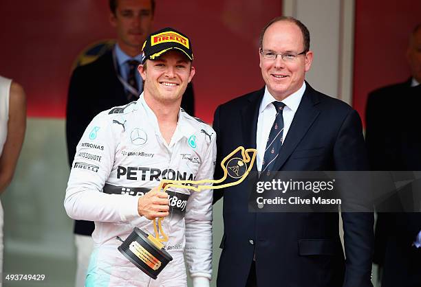 Nico Rosberg of Germany and Mercedes GP receives his winners trophy fom Prince Albert of Monaco during the Monaco Formula One Grand Prix at Circuit...