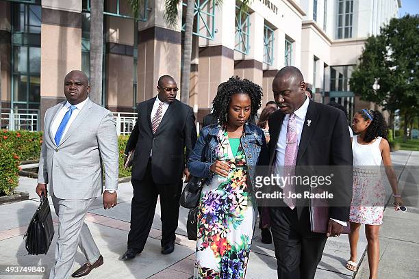 Benjamin Crump, an attorney for the Corey Jones' family, walks with Melissa Jones as they prepare to speak to the media during a press conference to...